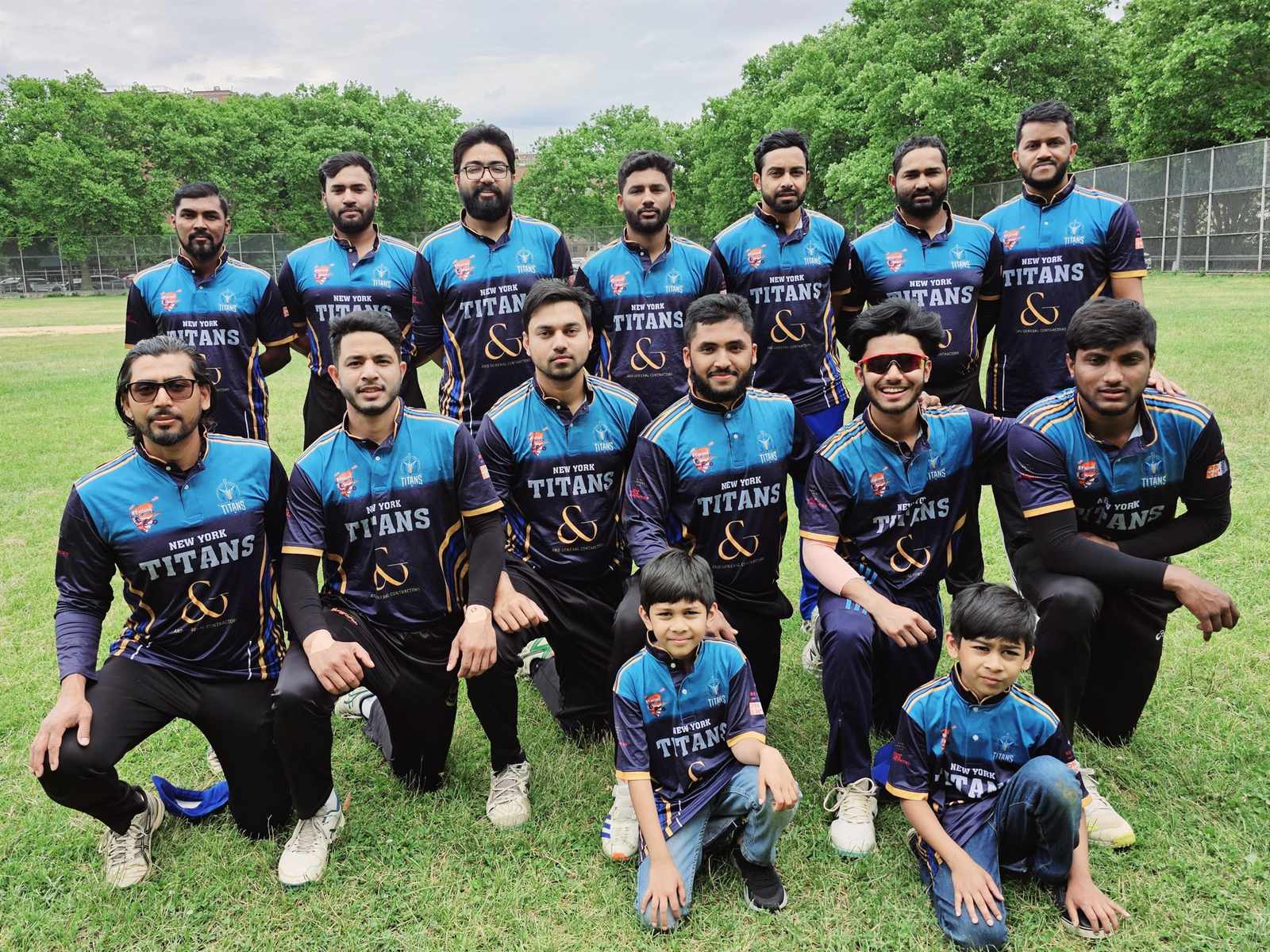 New York Titans players and youth members posing together on the field in New York in 2025.